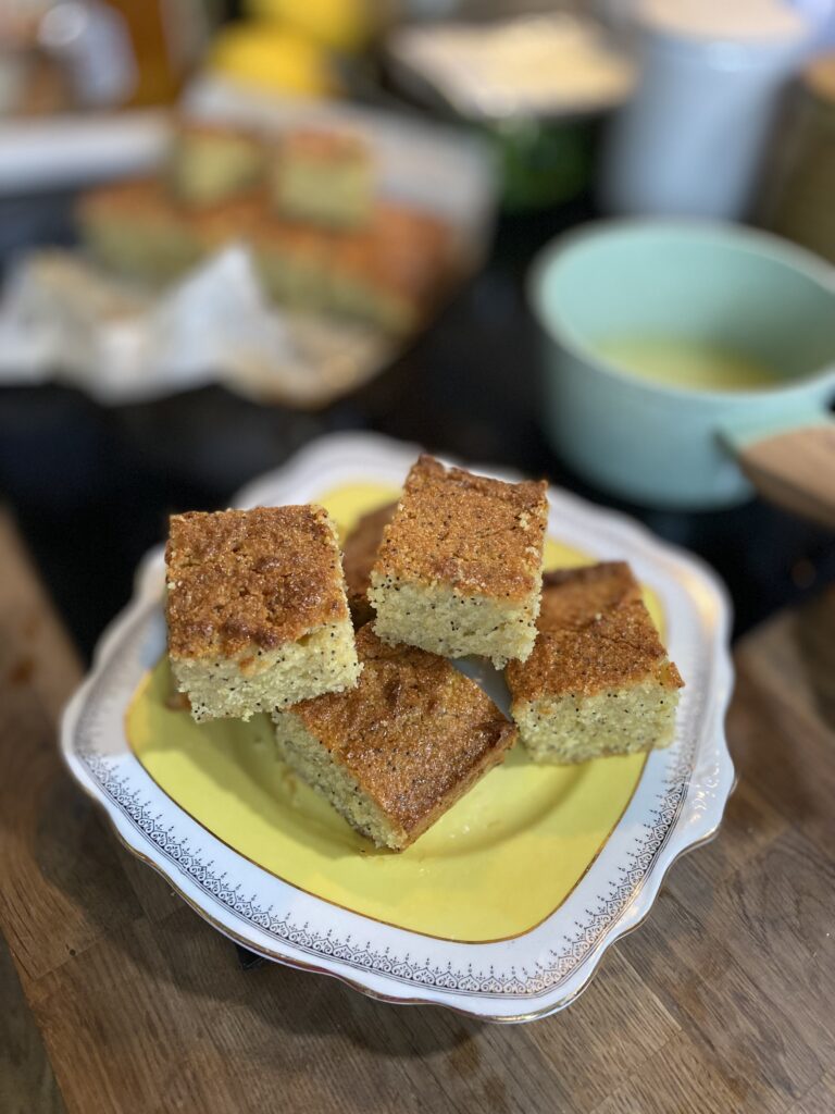 Yellow plate with white boarder and a couple of squares of cake