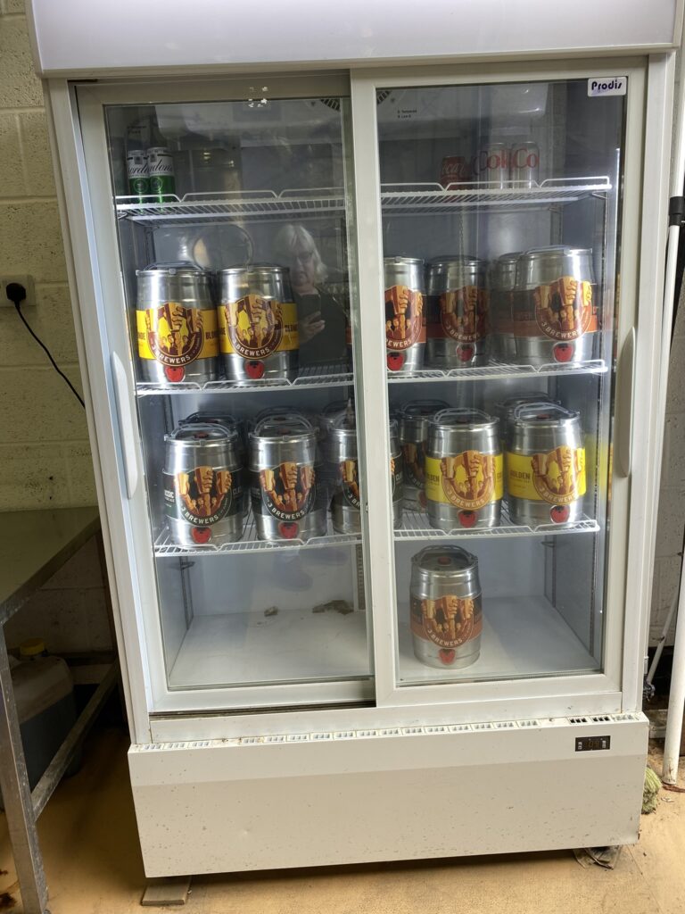 Fridge full of mini kegs ready to take away