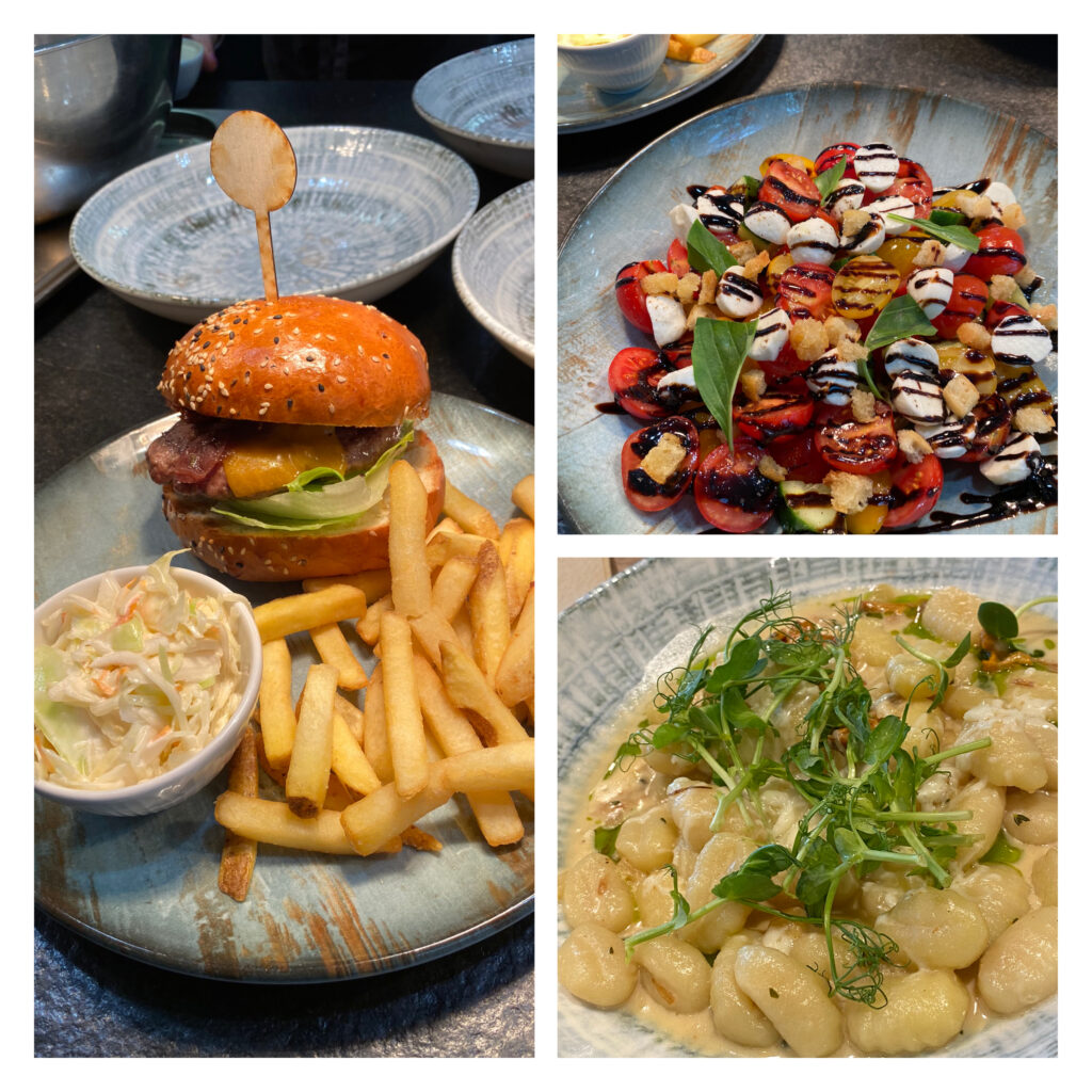 Photo of the delicious burger and fries, a beautiful and fresh salad as well as a creamy gnocchi