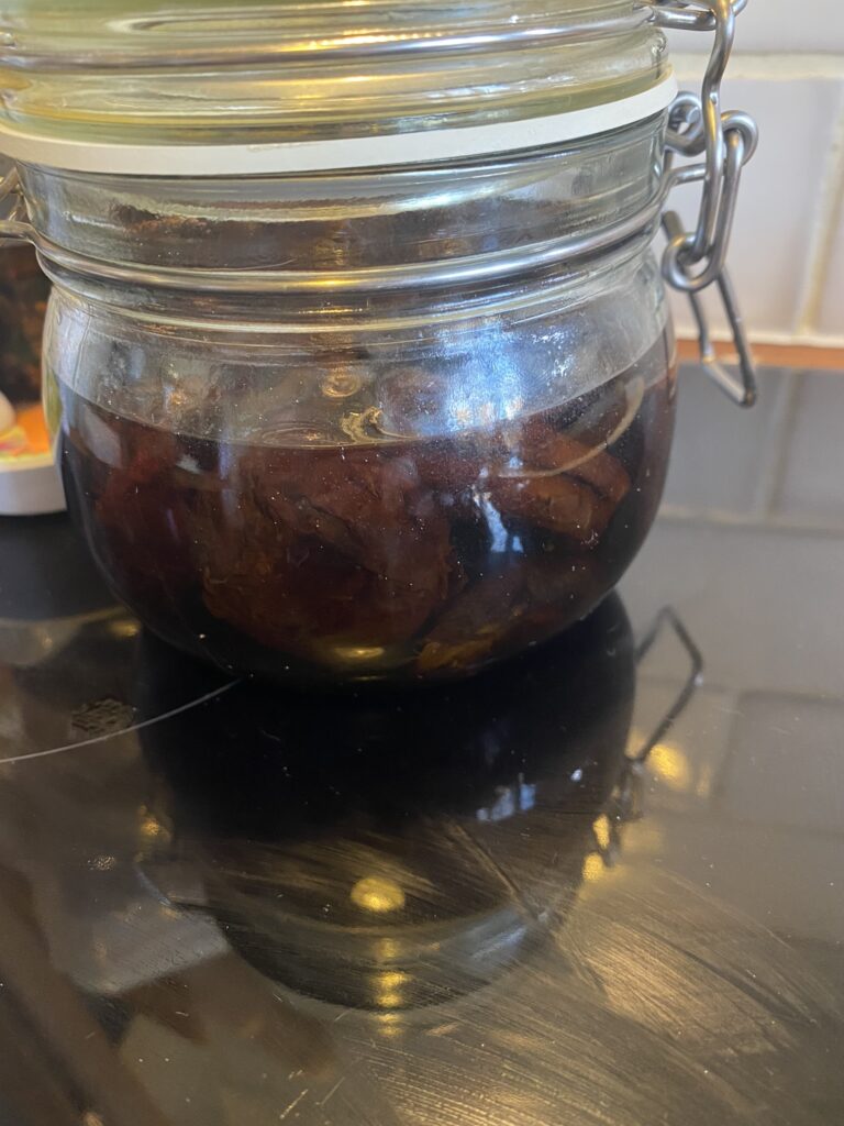 Jar with prunes covered in cognac