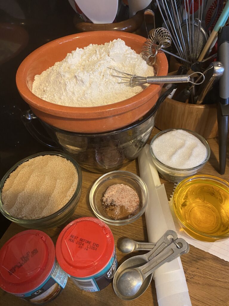 Ingredients weighed out and waiting to be turned into cake, flour, oil, spices and sugars